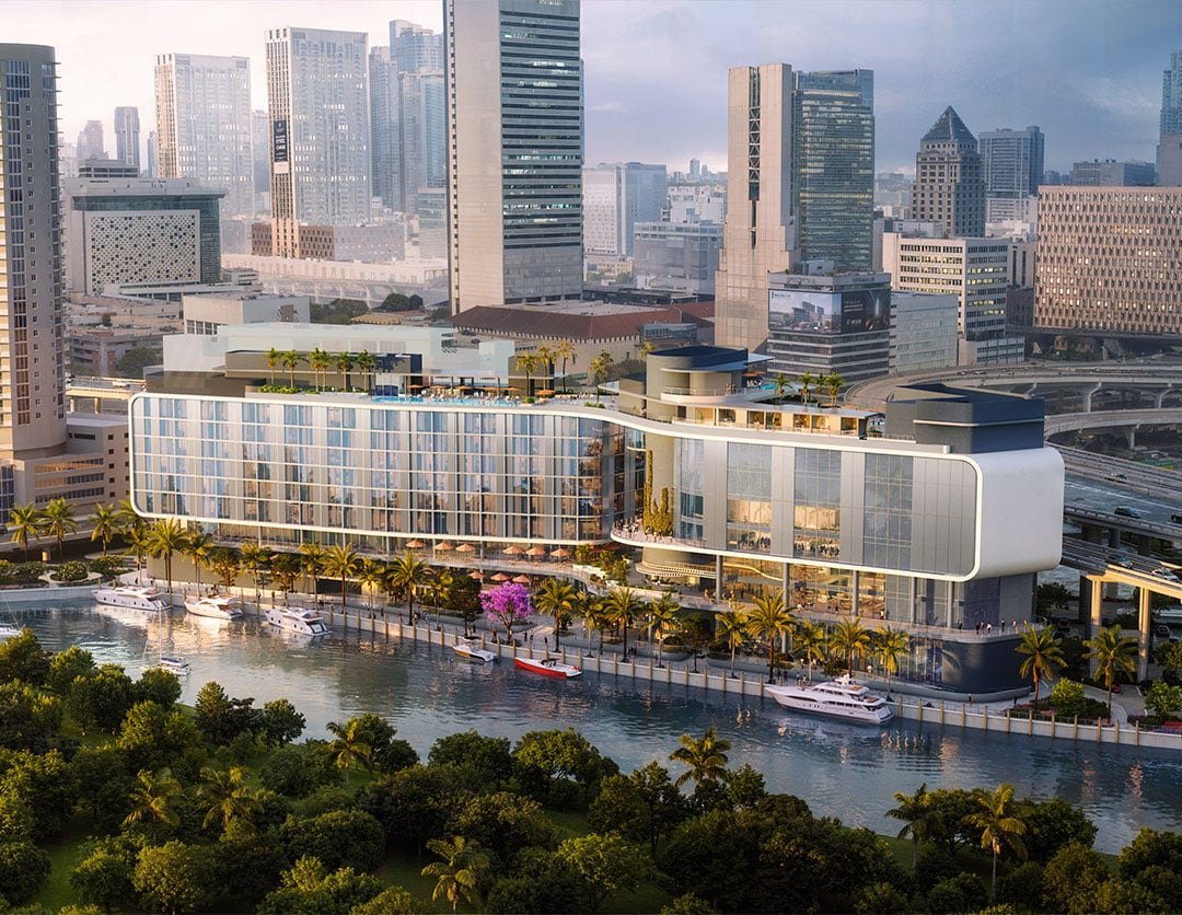 Rendering del complesso Riverside Wharf proposto, visto dall’altra sponda del fiume Miami, con le torri del centro sullo sfondo