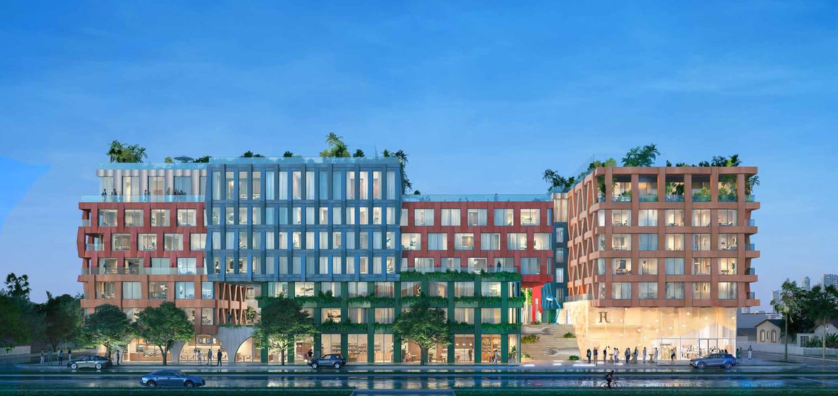 Rendu de la façade de WOMA au crépuscule, avec des boutiques le long de la rue